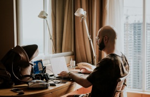 Man working from home on his laptop, at his desk.