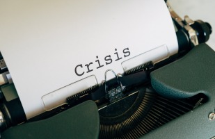 Typewriter print that says "crisis" 
